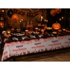 Kép 2/2 - Halloween asztalterítő – Csontváz kezek, véres Happy Halloween mintával